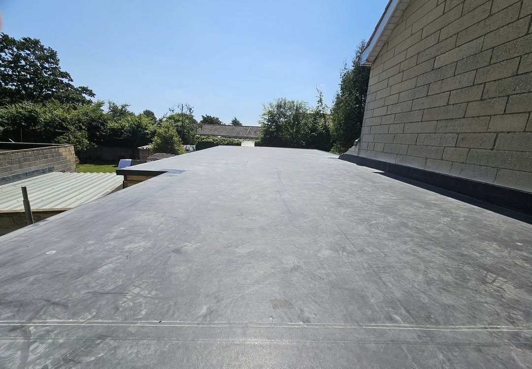 Professionally installed EPDM flat roofing system on a residential extension, providing a durable and weatherproof waterproof membrane.